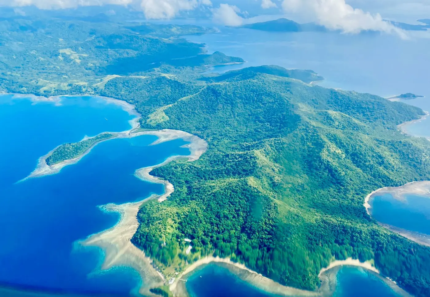 Aerial view of green ridges and reef-fringed bays on Vanua Levu, Fiji