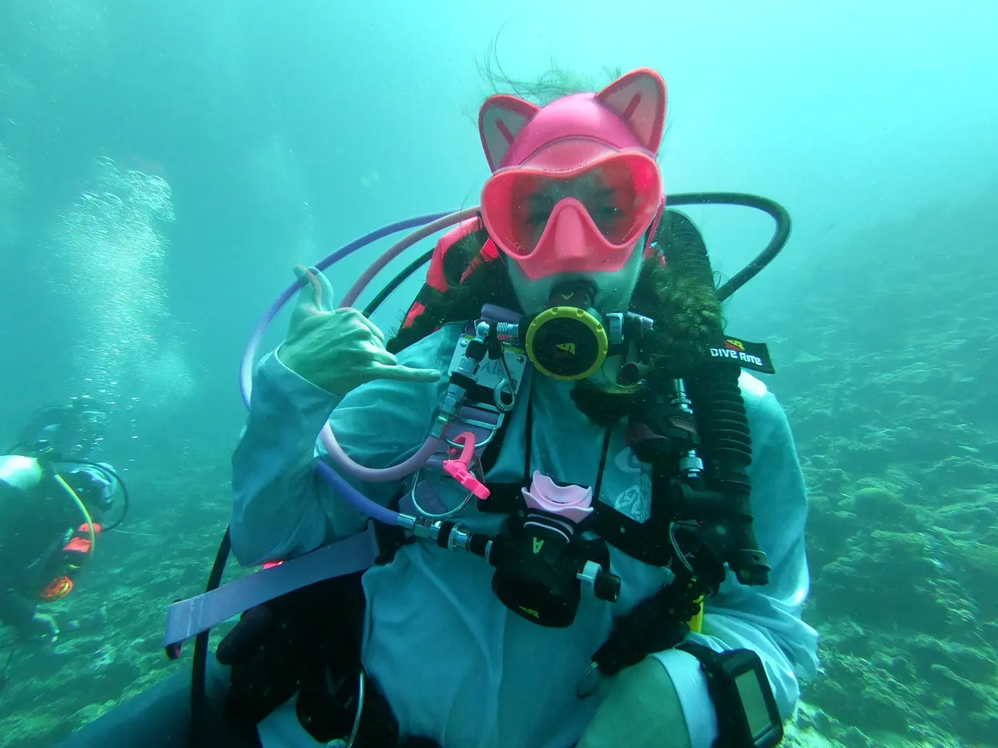 Allie in a pink cat-ear mask hood in the Red Sea
