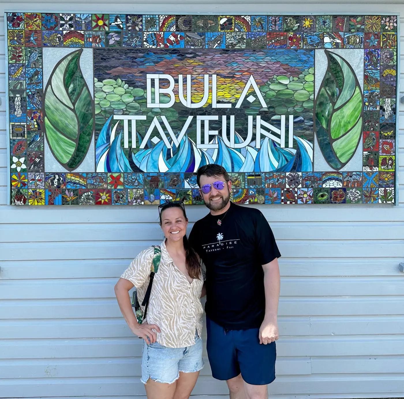 Eric and Allie in front of the Bula Taveuni mosaic sign
