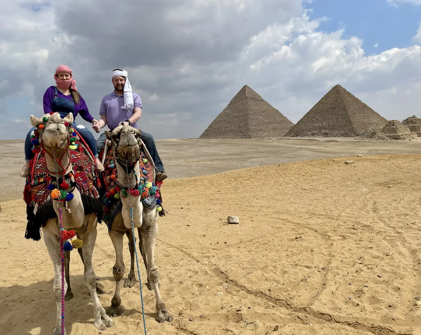 Eric and Allie on camels in front of the Giza pyramids