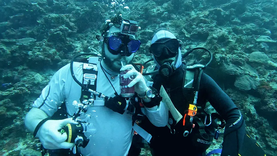 Eric drinking from a can at the 80-foot underwater dive bar in Fiji