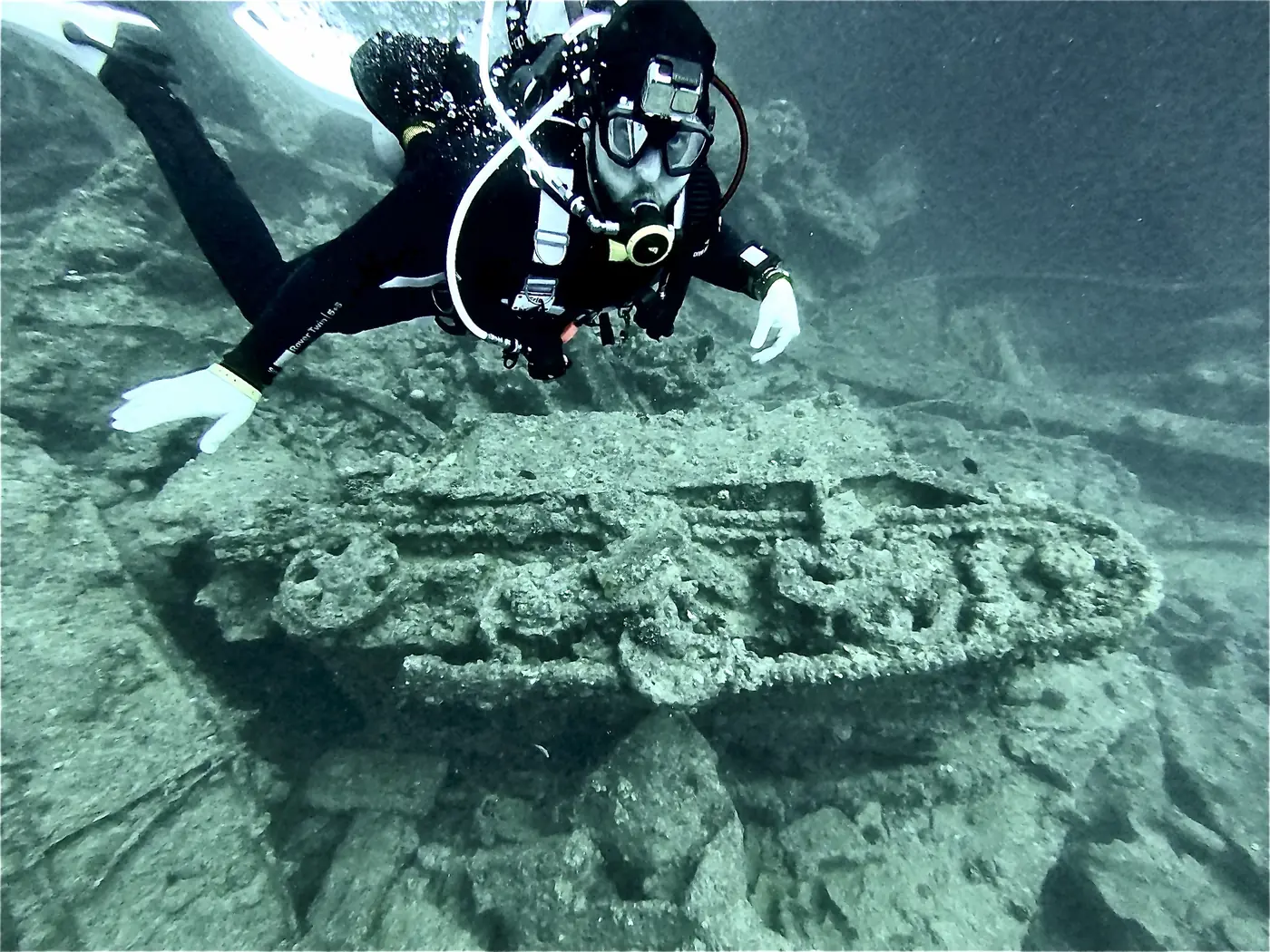 Eric hovering over a tracked carrier in the hold of the SS Thistlegorm