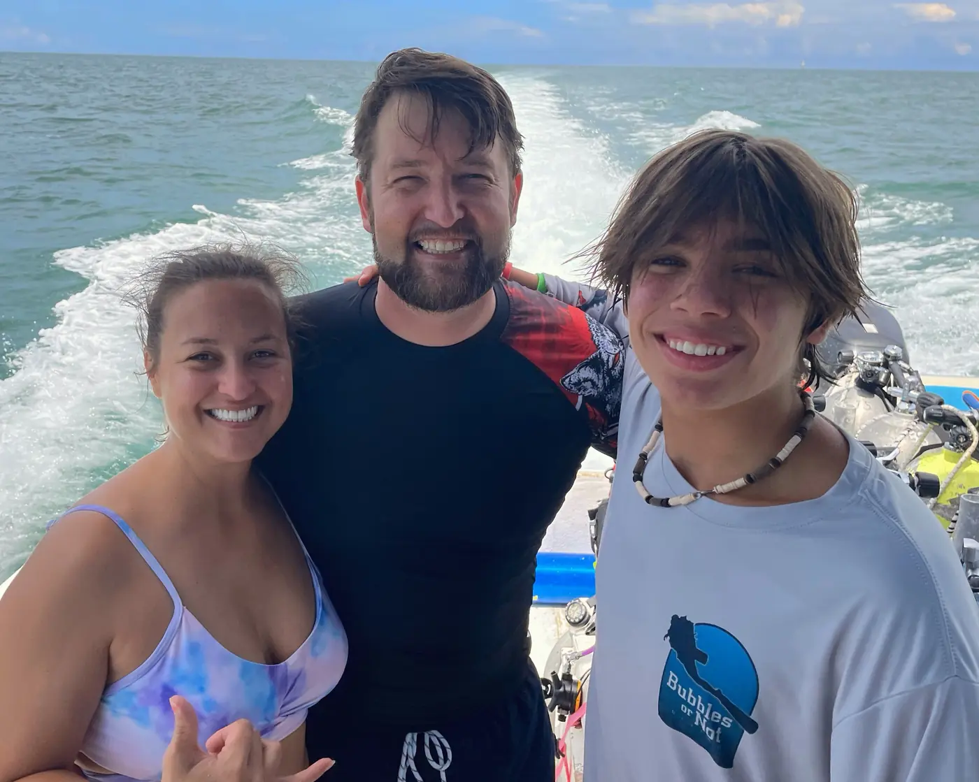 Eric, Allie and family smiling on the back of a dive boat off Tampa, Florida