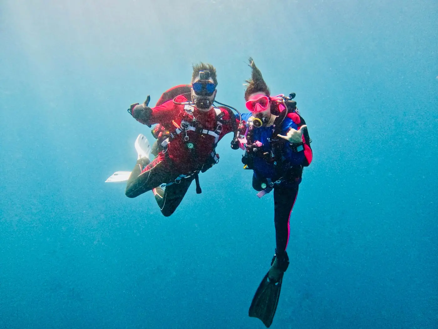 Eric and Allie Doolittle hovering together in open blue water